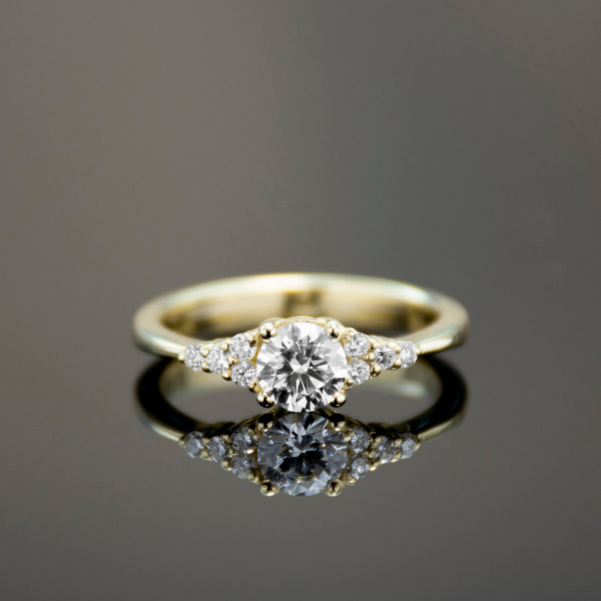 RG1924 Classic Minimalist Gold Ring with Central Diamond and Side Accent Diamonds
