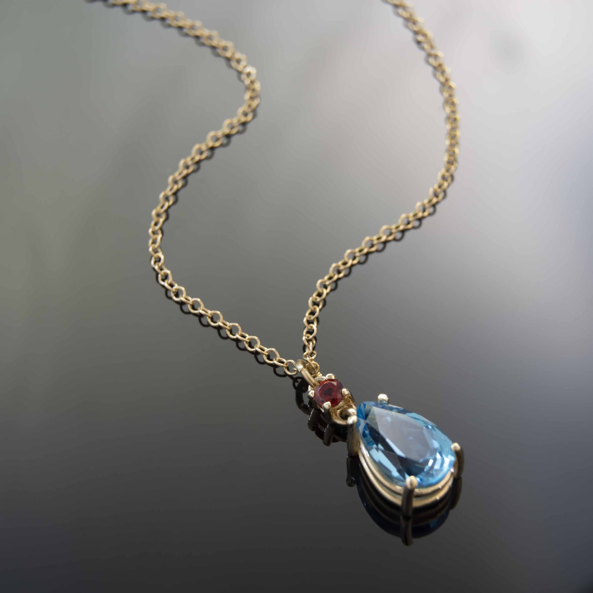 NG4805-1 Exquisite Pear-Shaped Blue Topaz and Garnet Pendant Necklace