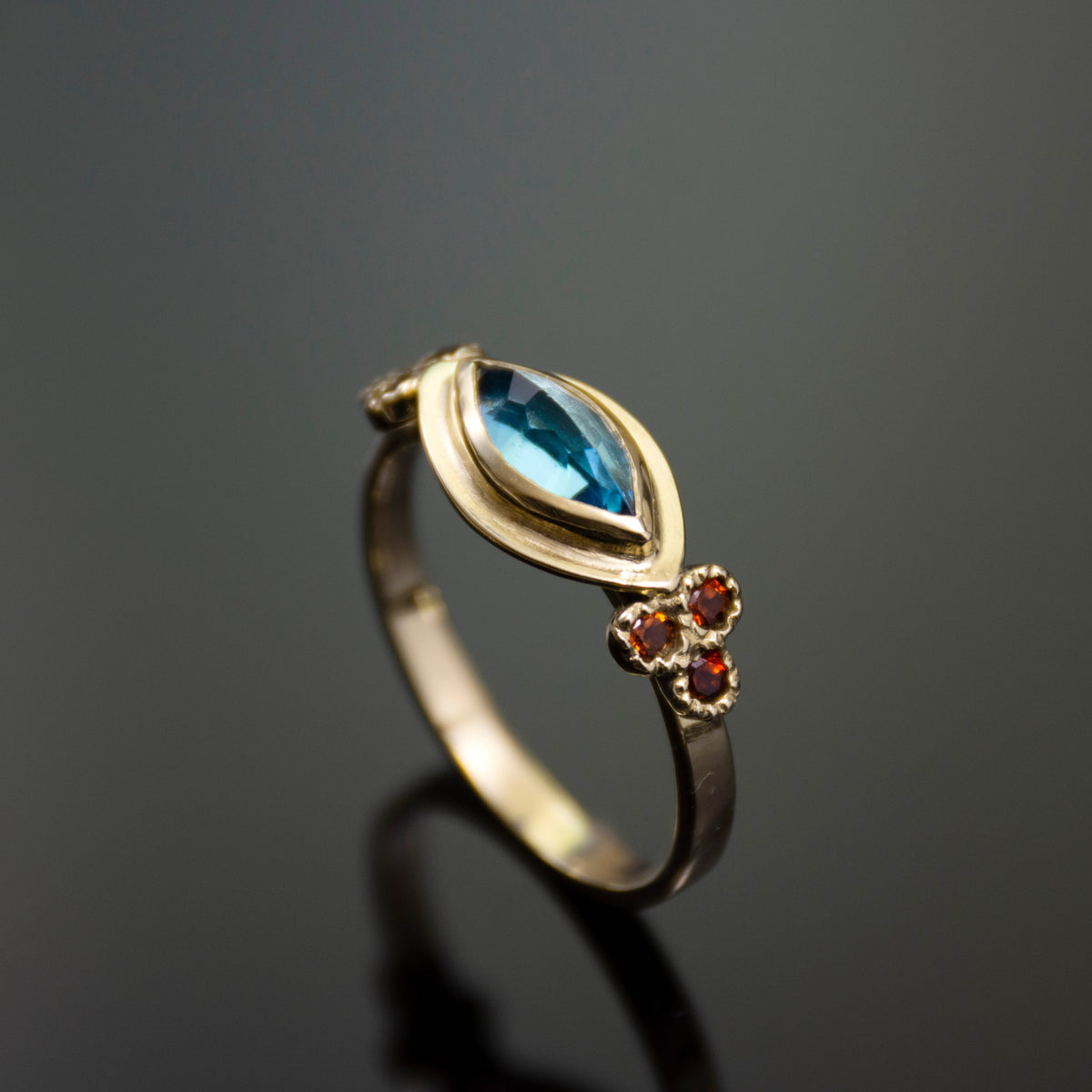 RG1870A-1 Gold Ring with Marquise Topaz and Garnet Accents