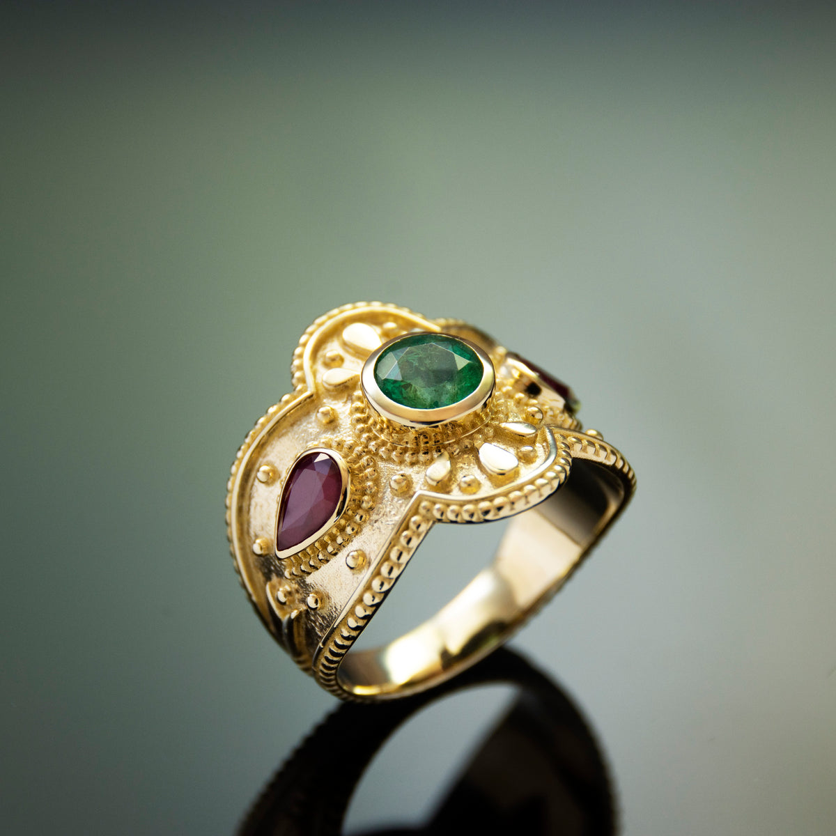 RG1934 Luxurious 14K Gold Statement Ring with Natural Emerald Centerpiece and Pear-Shaped Ruby Accents