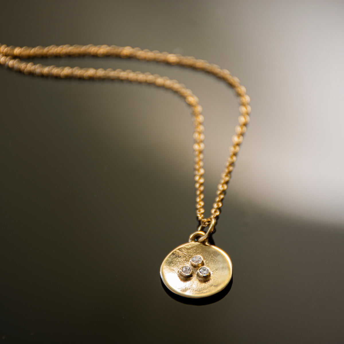 NG4767A Gold Round Charm Necklace with Three Diamonds