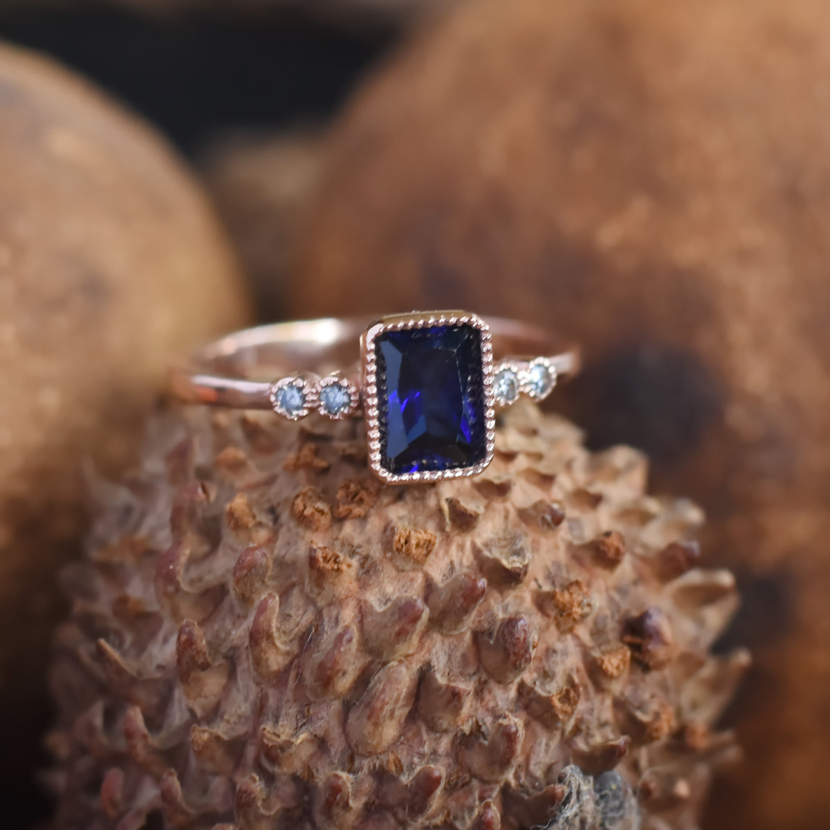 RG1834-2 Rose Gold Ring with Square Blue Sapphire and Zircon Accents