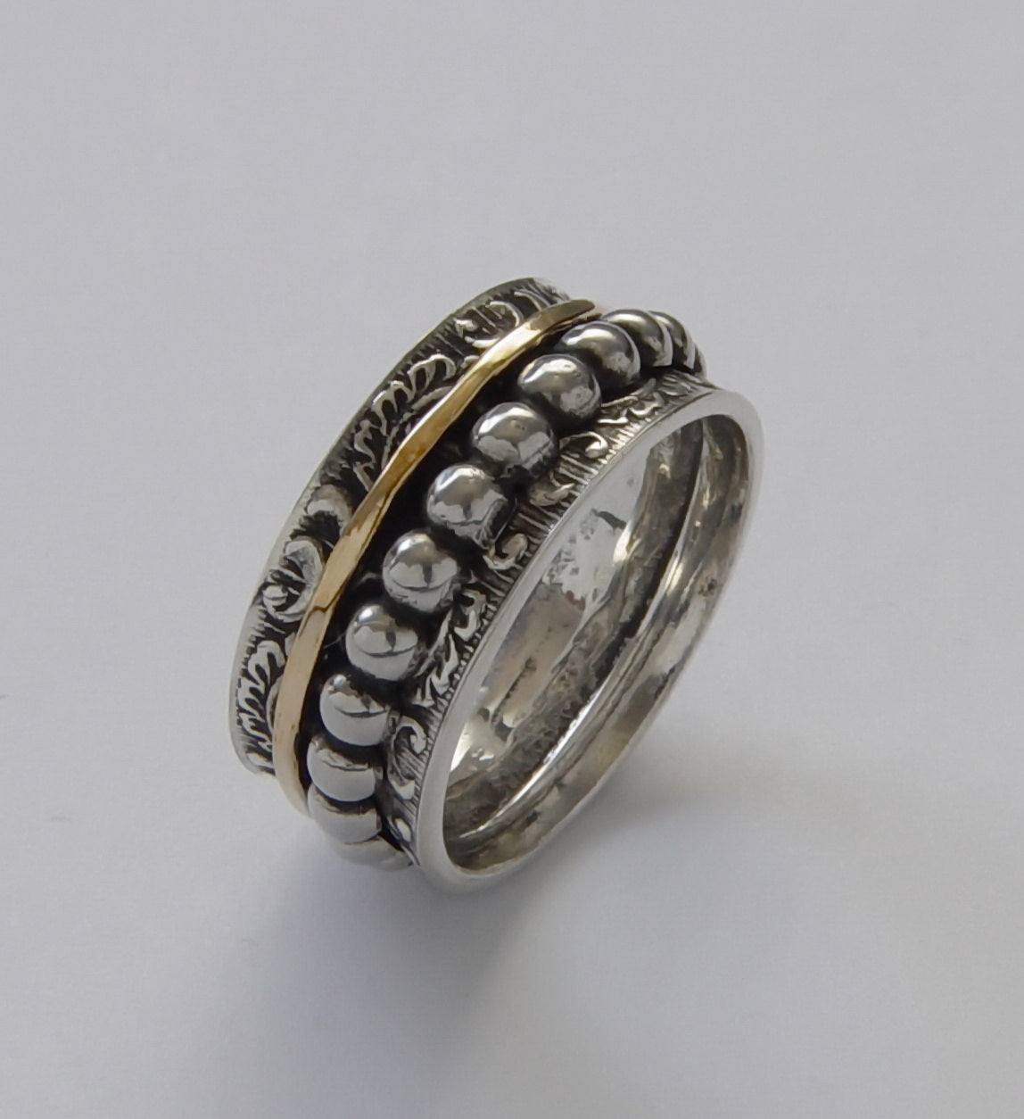 R1733B Braided silver band with gold spinner