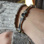 B0647F Silver and Gold Links Bracelet with Blue Topaz
